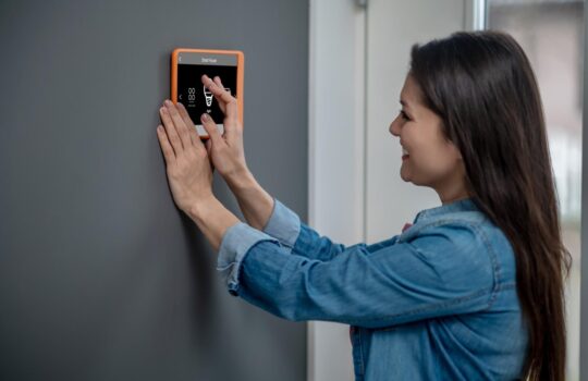 woman-touching-smart-home-device-choosing-mode